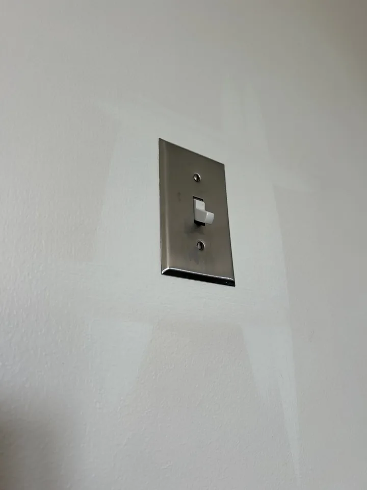 Close view of a smoothly finished wall around a light switch